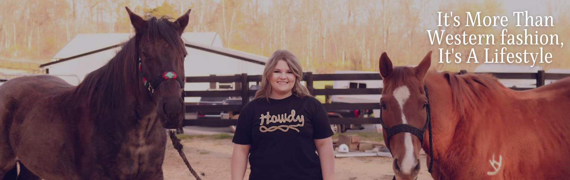 woman wearing black shirt that says howdy and holding the reins of two horses